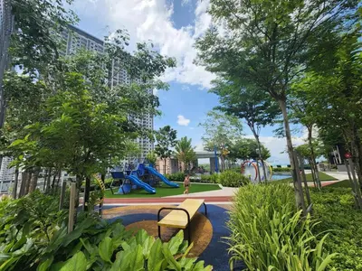 a park with a bench and a playground at Urban Suites - Family Suite in Jelutong