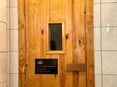 a wooden door with a sign on it at Urban Suites - Family Suite in Jelutong