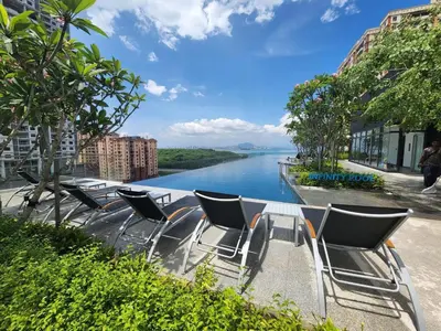a group of chairs sitting next to a river at Urban Suites - Family Suite in Jelutong