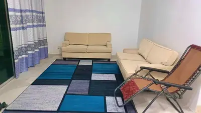 a living room with a couch and a chair at Homestay Hill View Lumut in Lumut
