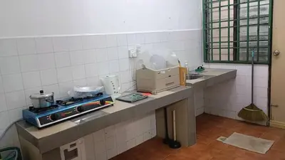 a kitchen with a counter with a box on it at Homestay Hill View Lumut in Lumut