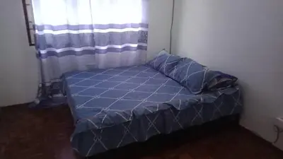 a small bed in a room with a window at Homestay Hill View Lumut in Lumut