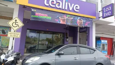 a silver car parked in front of a store at Homestay Hill View Lumut in Lumut