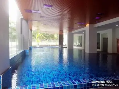 a large swimming pool in a building with blue tiles at Venus Home Retreat - Pool,Gym,Playground,Rooftop Garden View in Kampong Lumut Kiri