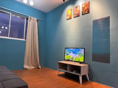 a living room with a television on a table at 1Br 2pax 1car only Malaysian guest only in Bayan Lepas
