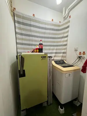 a green refrigerator and a trash can in a room at 1Br 2pax 1car only Malaysian guest only in Bayan Lepas