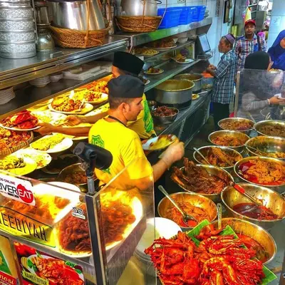 a group of people in a kitchen preparing food at 1Br 2pax 1car only Malaysian guest only in Bayan Lepas