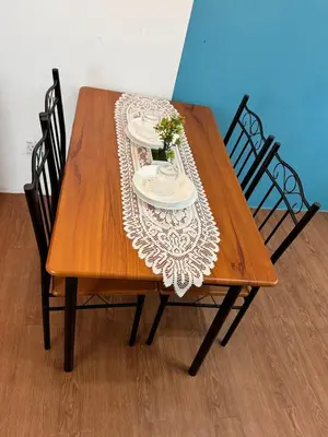 a wooden table with two plates and flowers on it at 1Br 2pax 1car only Malaysian guest only in Bayan Lepas