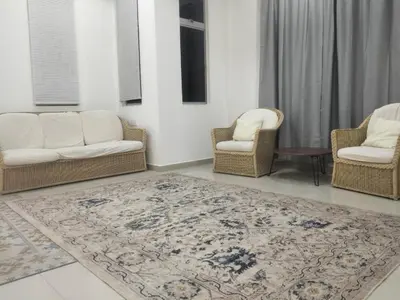 a living room with two chairs and a rug at Tenang Tambun House in Tanjung Rambutan