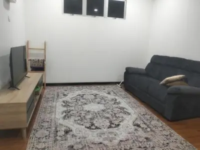 a living room with a couch and a flat screen tv at Tenang Tambun House in Tanjung Rambutan