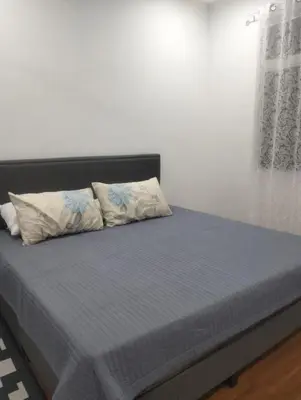 a bed with two pillows on it in a room at Tenang Tambun House in Tanjung Rambutan