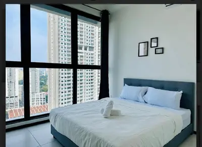 a bedroom with a large bed and large windows at Spacious 3BR Retreat Comfort & Style in the City 2-10pax in Jelutong