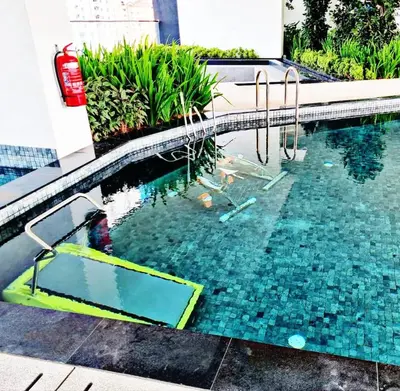 a swimming pool with a diving board in the water at Spacious 3BR Retreat Comfort & Style in the City 2-10pax in Jelutong