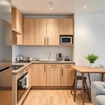 a kitchen with wooden cabinets and a table and a counter top at Jazz Suites Penang in Tanjong Tokong