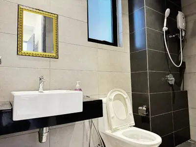 a bathroom with a sink and a toilet at Modern 3BR Getaway Perfect for Families & Groups 10 pax in Jelutong
