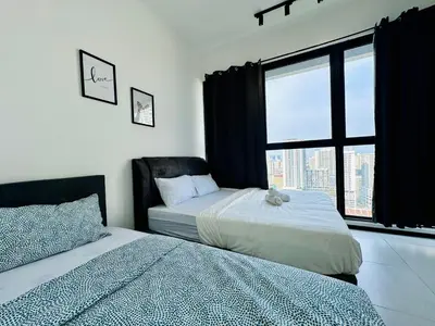 a bedroom with two beds and a window with a view at Modern 3BR Getaway Perfect for Families & Groups 10 pax in Jelutong