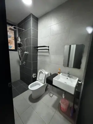 a bathroom with a toilet and a sink at Cozy & Chic 3BR Apartment Great Location 2-10pax in Jelutong