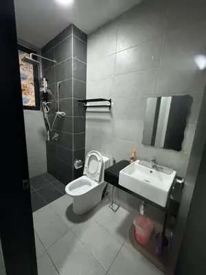 a bathroom with a toilet and a sink at Cozy & Chic 3BR Apartment Great Location 2-10pax in Jelutong