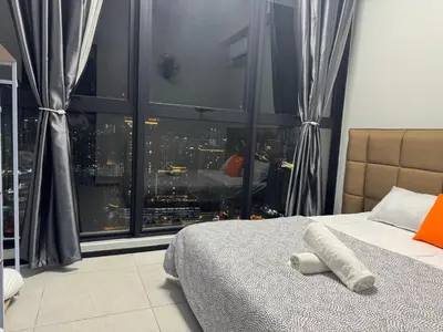 a bedroom with a large window with a city view at Cozy & Chic 3BR Apartment Great Location 2-10pax in Jelutong