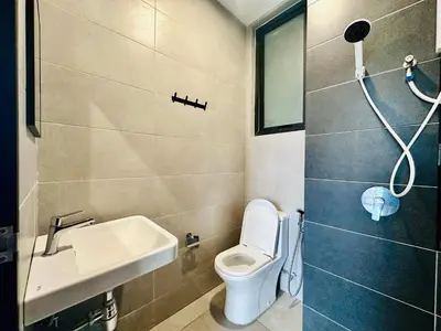 a small bathroom with a toilet and a sink at Spacious 3BR Retreat Comfort & Convenience in Prime Location 2-10pax in Jelutong