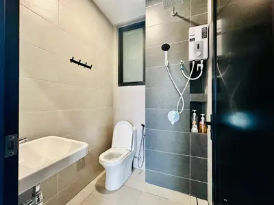 a bathroom with a toilet and a sink at Spacious 3BR Retreat Comfort & Convenience in Prime Location 2-10pax in Jelutong