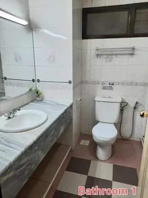 a bathroom with a toilet and a sink at KEA Farm Chilly Cozy Resort Copthorne in Brinchang