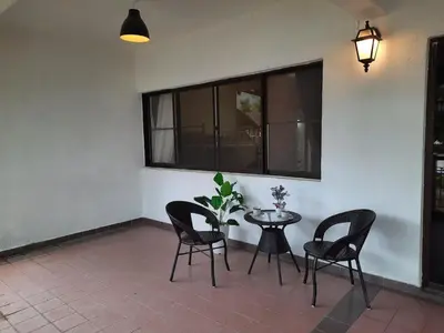 a patio with a table and chairs and a plant at KEA Farm Chilly Cozy Resort Copthorne in Brinchang
