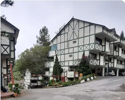 a large white building with trees in front of it at KEA Farm Chilly Cozy Resort Copthorne in Brinchang