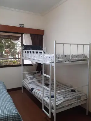 two bunk beds in a room with a window at KEA Farm Chilly Cozy Resort Copthorne in Brinchang