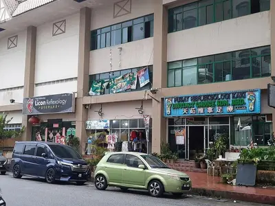 two cars parked in front of a building at KEA Farm Chilly Cozy Resort Copthorne in Brinchang