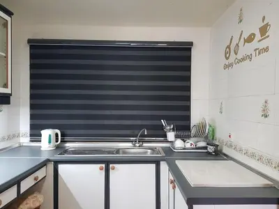 a kitchen with a sink and a window in it at Kea Farm Sweet Cozy Resort Copthorne in Brinchang