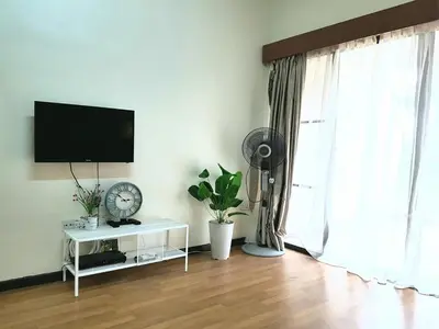 a living room with a flat screen tv and a fan at Kea Farm Sweet Cozy Resort Copthorne in Brinchang