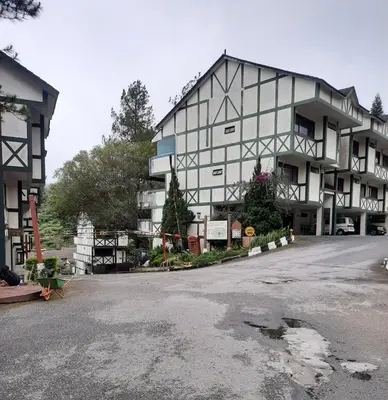 a large building sitting on the side of a street at Kea Farm Sweet Cozy Resort Copthorne in Brinchang