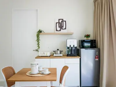 a small kitchen with a table and a refrigerator at Urban Seaview Home in George Town
