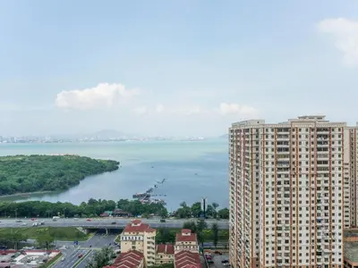 a large building next to a large body of water at Urban Seaview Home in George Town