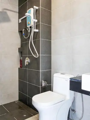 a bathroom with a toilet and a shower at Urban Seaview Home in George Town