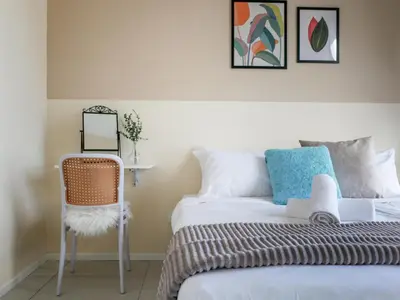 a bedroom with a bed and a chair at Urban Seaview Home in George Town