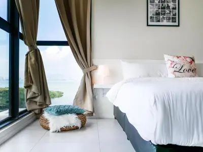 a bedroom with a bed and a large window at Urban Seaview Home in George Town