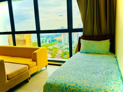 a bedroom with a bed and a chair and a window at Perfect for Groups! 2BR with 5 Queen Beds & WiFi in Jelutong