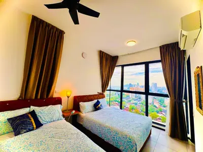 a hotel room with two beds and a window at Perfect for Groups! 2BR with 5 Queen Beds & WiFi in Jelutong
