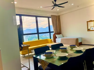 a living room with a couch and a table with bowls on it at Modern 2BR Home 5 Queen Beds, Near Attractions in Jelutong