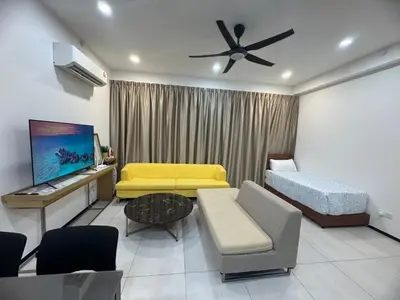 a living room with a couch and a bed at Modern 2BR Home 5 Queen Beds, Near Attractions in Jelutong