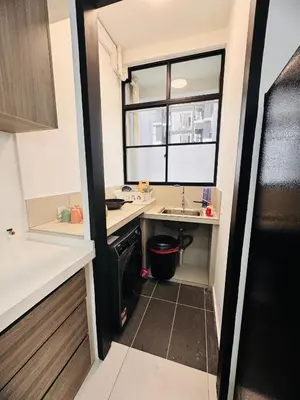 a small kitchen with a sink and a window at Relax & Unwind 2BR Apartment with 5 Queen Beds in Jelutong