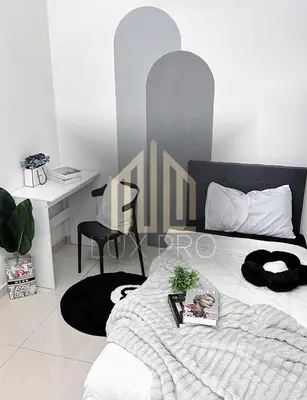 a bedroom with a bed with a desk and a chair at Residensi prima kampung paloh in Ipoh