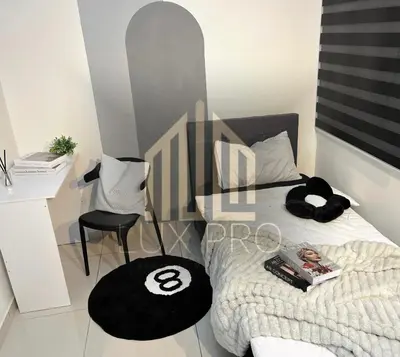 a bedroom with a bed with a desk and a chair at Residensi prima kampung paloh in Ipoh