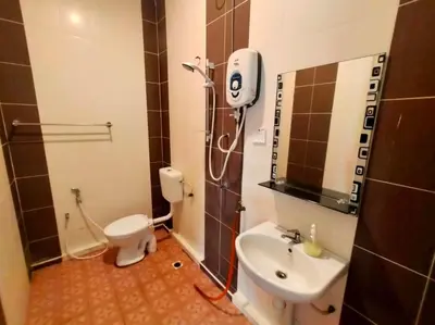 a small bathroom with a toilet and a sink at Capital O 91118 Chalet Seri Idaman in Kampong Batu Maung