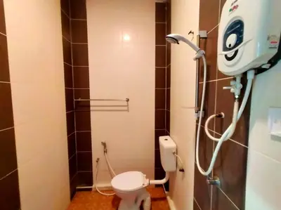 a small bathroom with a toilet and a shower at Capital O 91118 Chalet Seri Idaman in Kampong Batu Maung