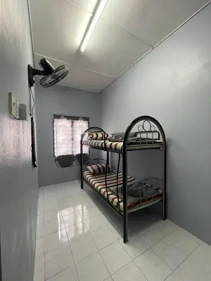 a room with two bunk beds in a room at Teratak Bonda Homestay Seri Iskandar in Seri Iskandar