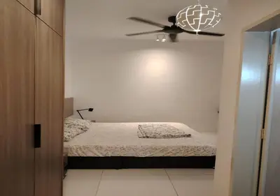 a bedroom with a bed and a ceiling fan at Cosy Townhouse in Tasek Gelugor in Ara Rendang