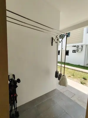 a room with a wall with some utensils on it at Cosy Townhouse in Tasek Gelugor in Ara Rendang